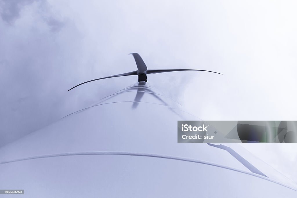 Windmill - Wind turbine Windmill from below with cloudy sky background white and gray and one number engraved on the tower or mast - Aerogenerador desde abajo con fondo de cielo nublado blanco y gris y numero 1 grabado en la torre o mastil Choice Stock Photo