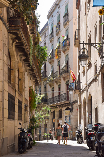 August 17, 2017 - Barcelona, Spain: Couple walking on a quiet secluded European city downtown street