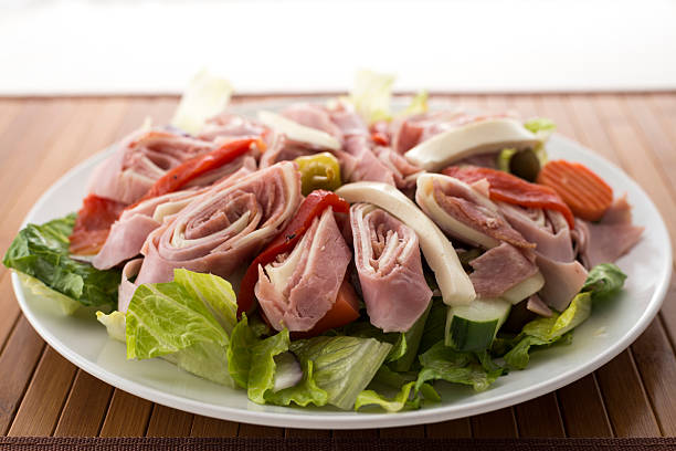 salat mit italienischen kalten antipasti auf einer platte - antipasto stock-fotos und bilder