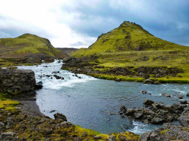 Immerse yourself in the enchanting beauty of Thórsmörk, Iceland, with this captivating photograph. The scenic view unfolds as a picturesque river gracefully meanders from left to right, set against the backdrop of majestic mountains. The serene landscape captures the essence of Thórsmörk's natural allure, inviting viewers to experience the tranquility of this Icelandic gem. Perfect for a variety of creative projects, this high-quality stock photo encapsulates the breathtaking beauty of Thórsmörk, where nature's wonders unfold in every frame.