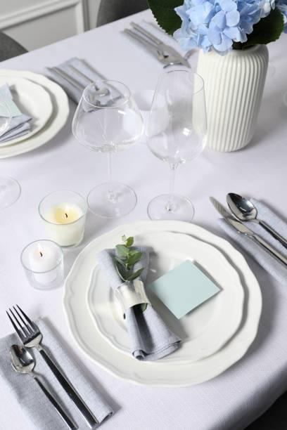 istock Beautiful table setting with blank card and floral decor, above view 1855493467