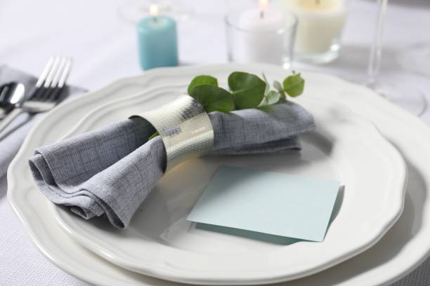 istock Beautiful table setting with blank card and floral decor, closeup 1855493989