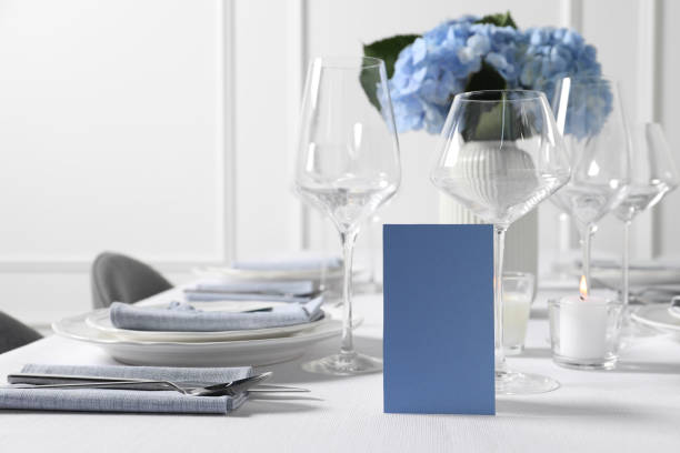istock Beautiful table setting with blank card and floral decor indoors 1855493993