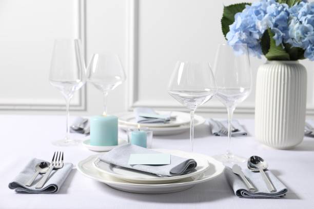 istock Beautiful table setting with card and floral decor indoors 1855495563