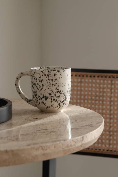 istock Black and white ceramic cup on travertine coffee table. Wabi-sabi interior details for decoration 1855505414