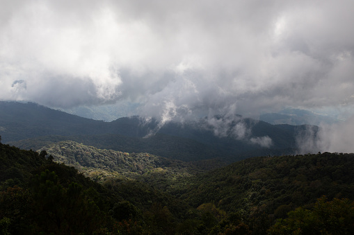 Stormy and dramatic clouds move through the jungles and tall mountains in Doi Inthanon National Park in Northern Thailand