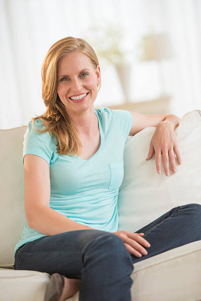 istock Happy Young Woman Relaxing On Sofa 185552639