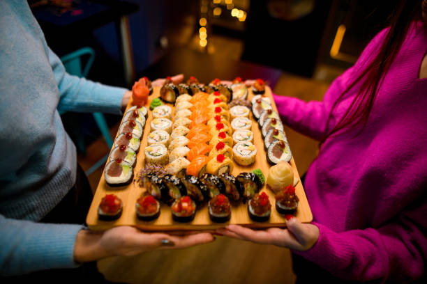 istock Sushi Joy by the Christmas Tree, Two Girls in a Festive Setting 1855528010