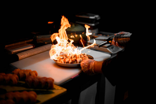 Modern kitchen. Cooks prepare meals on the stove in the kitchen of the restaurant or hotel. The fire in the kitchen