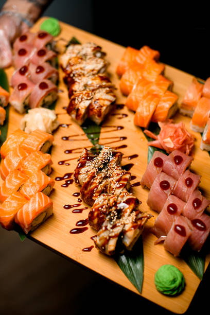 istock Sushi Symphony. Tuna, Sesame, Teriyaki Rolls on Fresh Greens 1855540402