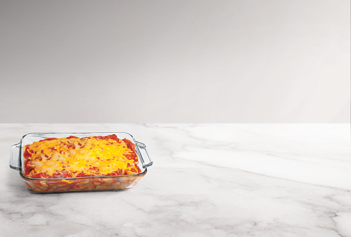 Cooked lasagna on a countertop with no people and empty background