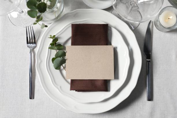 istock Beautiful table setting with blank card and floral decor, flat lay 1855557566