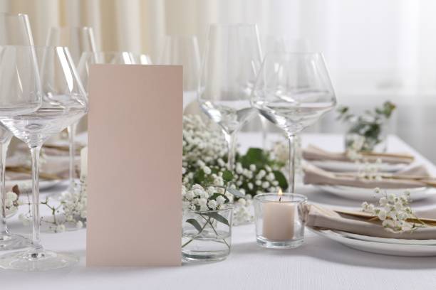 istock Beautiful table setting with blank card and floral decor 1855559194