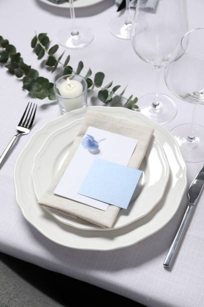 istock Beautiful table setting with card and floral decor 1855560768