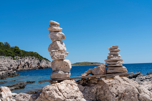 Stacked stones against clear blue sky in Telascica, national park in Dugi otok island, Croatia