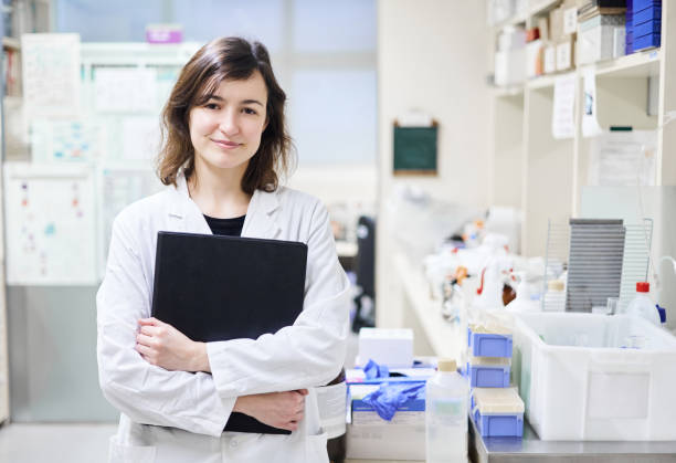 istock Smiling scientist standing with her arms folded in a laboratory 1855595976