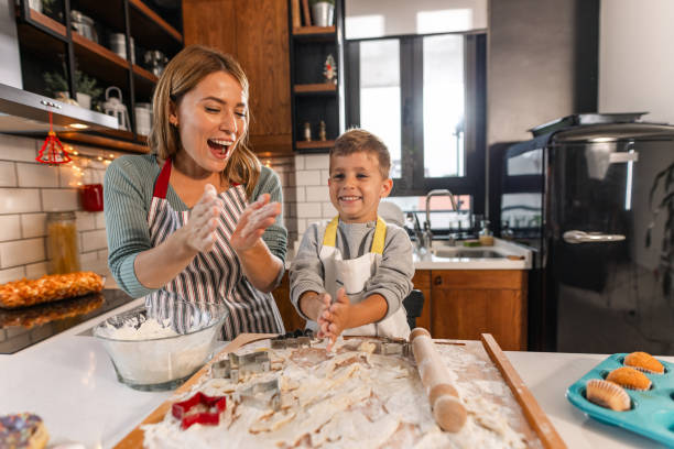 istock A young boy is helping his mother in the kitchen 1855597583