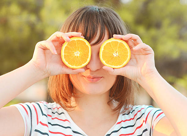 istock Young woman having fun with oranges 185559940