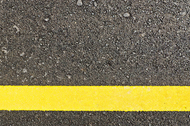 istock Closeup to asphalt road with the yellow line 185560257
