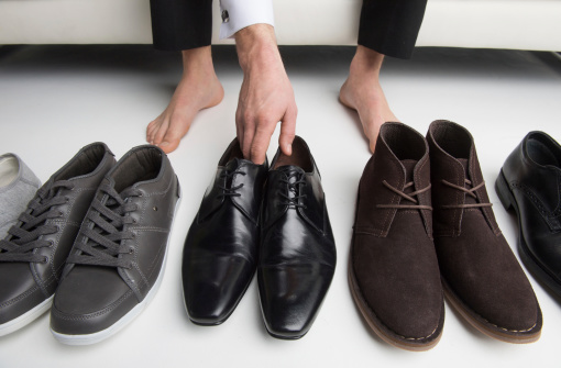 Men choose which pair of shoes to wear