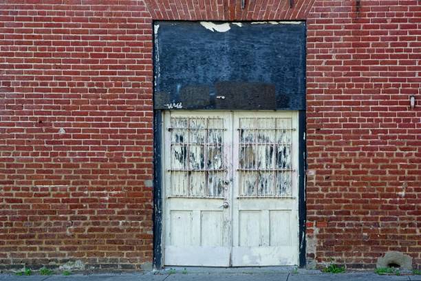 istock Weathered wooden doors to red brick building 1855633827