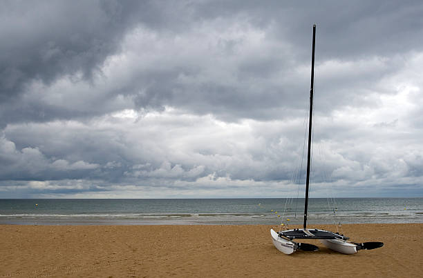 Catamaran sailboat on a beach stock photo