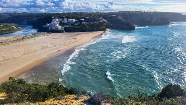 istock Praia De Odeceixe Mar Beach With Golden Sand, Atlantic Ocean, River Bend and White Houses of Odeceixe Village. Rota Vicentina Coast, Odemira, Portugal. Hiking Rota Vicentina the Fisherman's Trail 1855662247