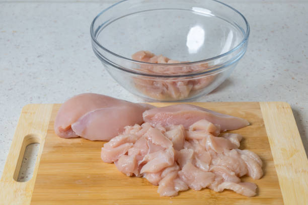 istock Raw meat - chicken breast on the kitchen table. 1855662773