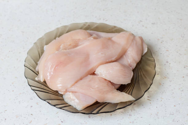 istock Raw meat - chicken breast on the kitchen table. 1855663312
