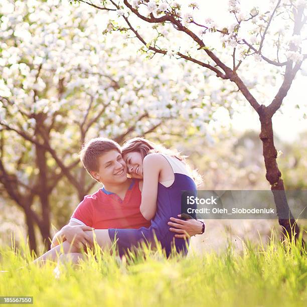 Couple Sitting On Grass Stock Photo - Download Image Now - Couple - Relationship, Gardening, Happiness