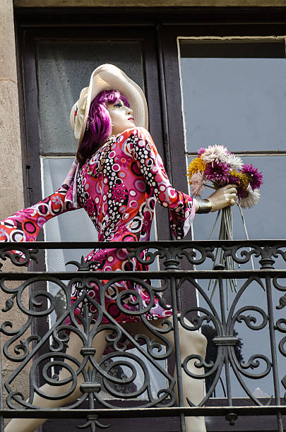 a plastic woman doll holding flowers in her hand . Barcelona 2013
