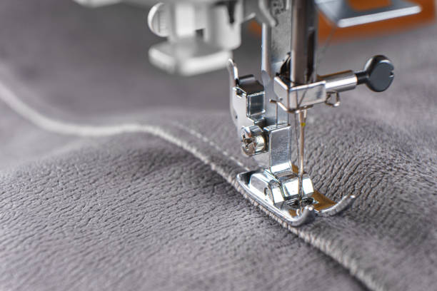 istock Modern sewing machine with gray velours fabric close up 1855690933