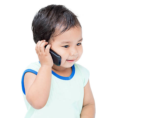 istock Cute Boy Speaking by cellular Phone 185569121