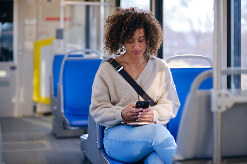 A woman commuting on a light rail transit train.