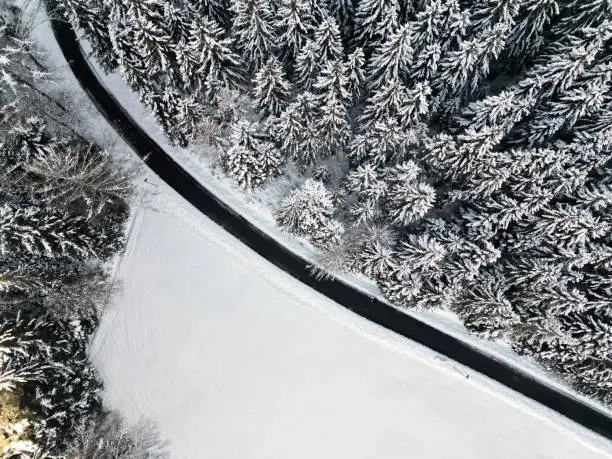 Winter road through snow covered forest in Baiersbronn, Black Forest, Germany