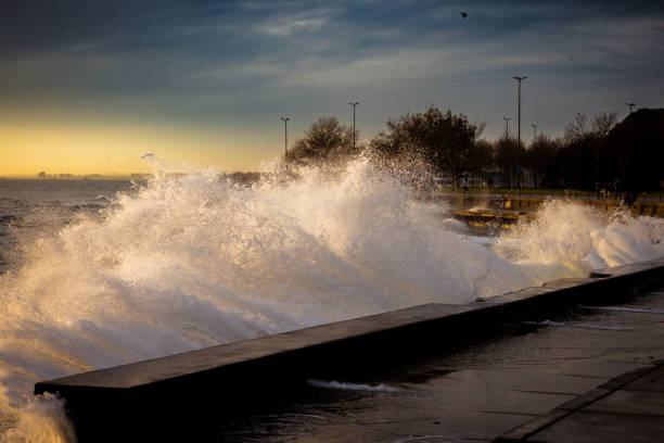 istock Sea waves splash on the coastline at sunset. 1855724719