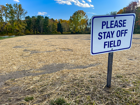 Construction photo of a please stay off field sign on a sports field or pitch