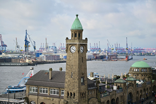 Amsterdam Centraal Railway Station in the Netherlands viewed from outside and showing the waterbuses and transport to other parts of Amsterdam, Netherlands.