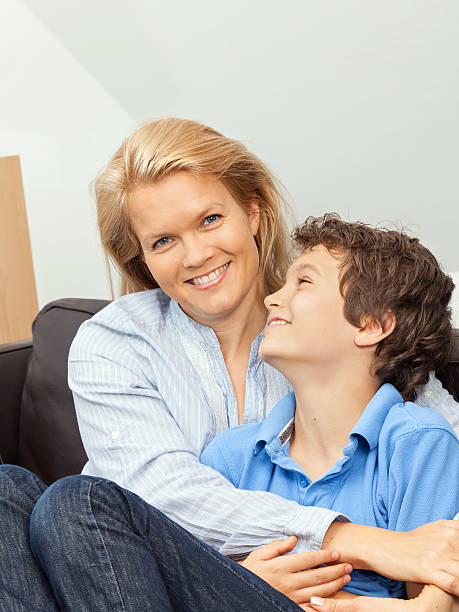 istock Mother and son sitting on a couch 185573907