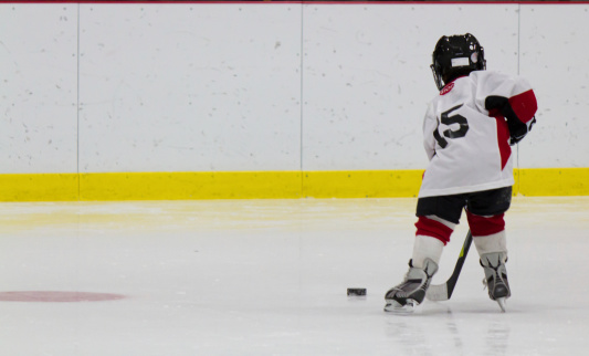 Little boy playing ice hockey