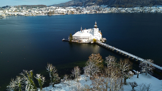 The Ort lake castle on an island on Lake Traunsee in Gmunden in winter with snow