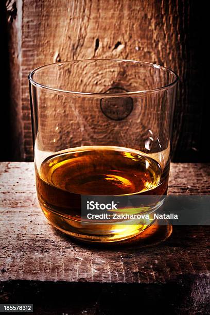 Whiskey Scotch In A Glass And Bottle On Old Wooden Stock Photo - Download Image Now