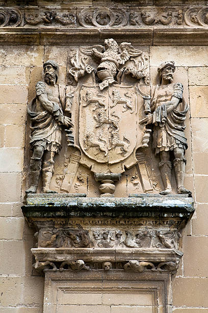istock Shield of stone framed by two men 185578458