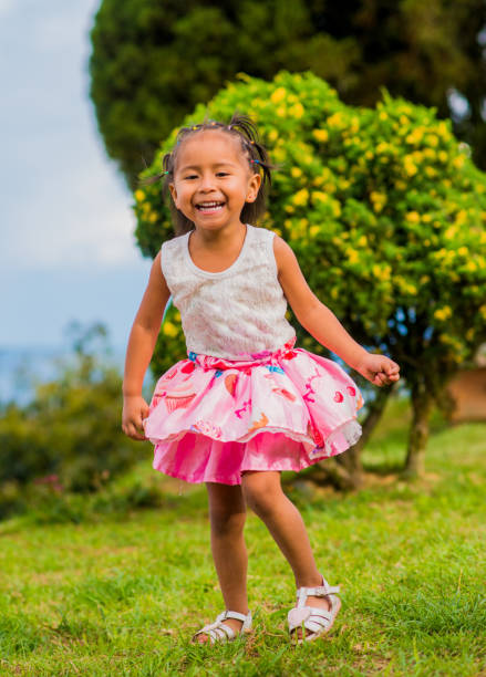 istock little girl playing and running in the open air while smiling happily 1855785349