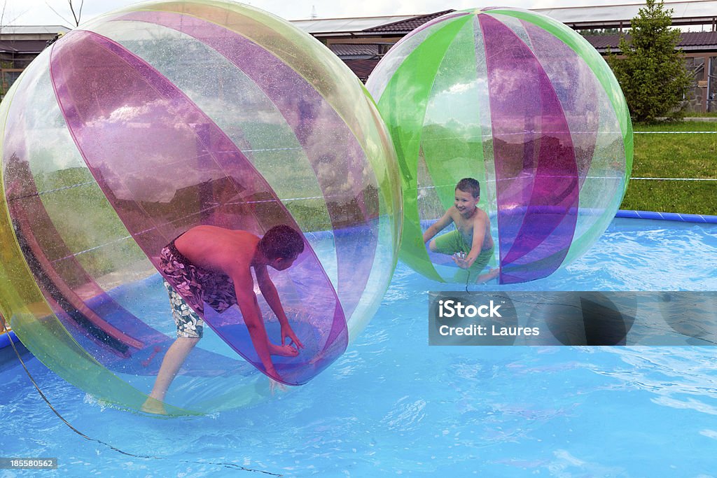 Water Zorbing Boys in a balls on the water. Water Zorbing Sphering Stock Photo