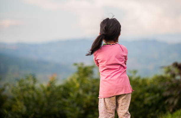 istock little girl turning her back while looking at the scenery around her 1855823803