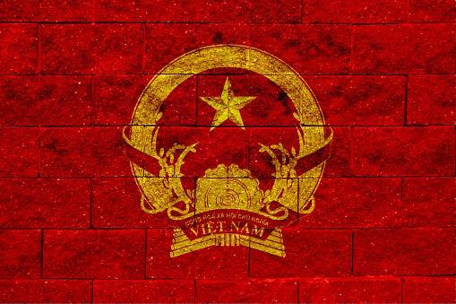 Flag and coat of arms of Socialist Republic of Vietnam on a textured background. Concept collage.