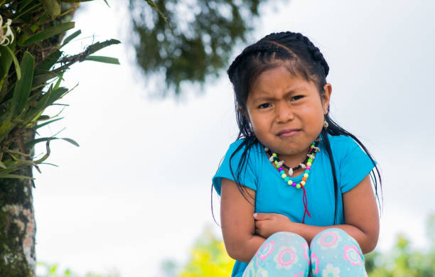 istock portrait of little girl looking forward while outdoors and making bad gesture at 1855831592