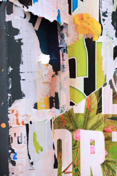 istock Pieces of torn paper peeling off wall used as billboard 1855836735