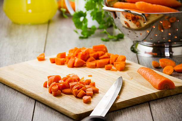 istock Chopped raw carrots on board with knife 185584019